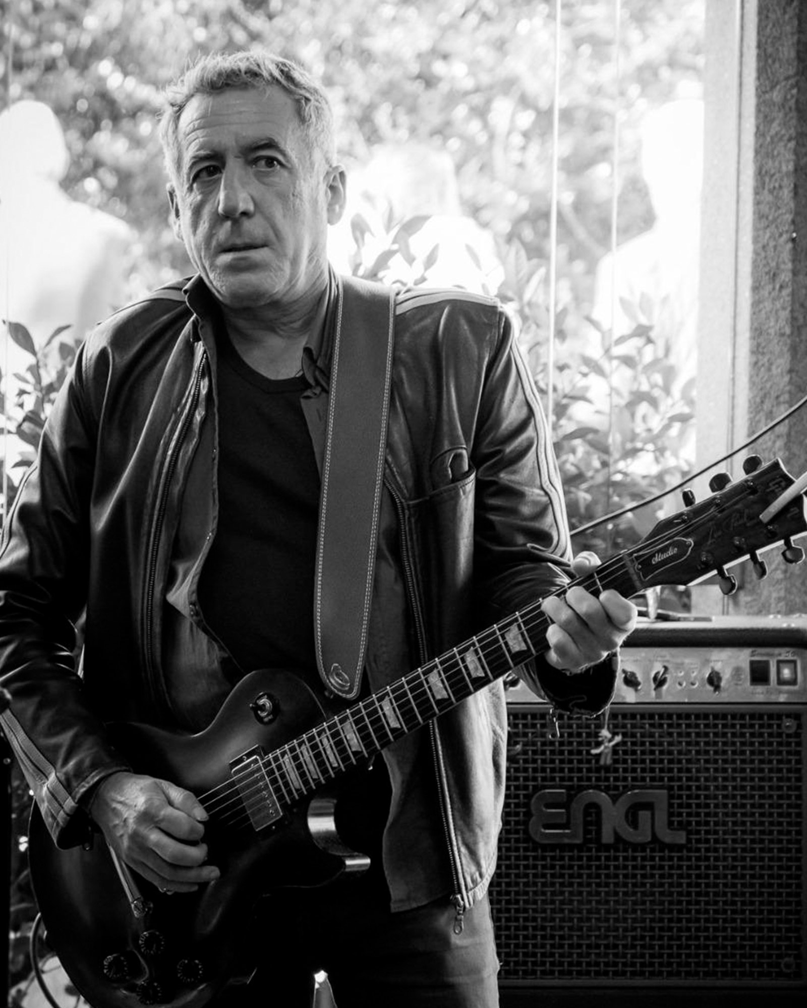 Alberto Regueira tocando unha guitarra acústica nun escenario